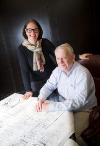Alternate image of John Clark and JoAnn Daniels looking over some blueprints