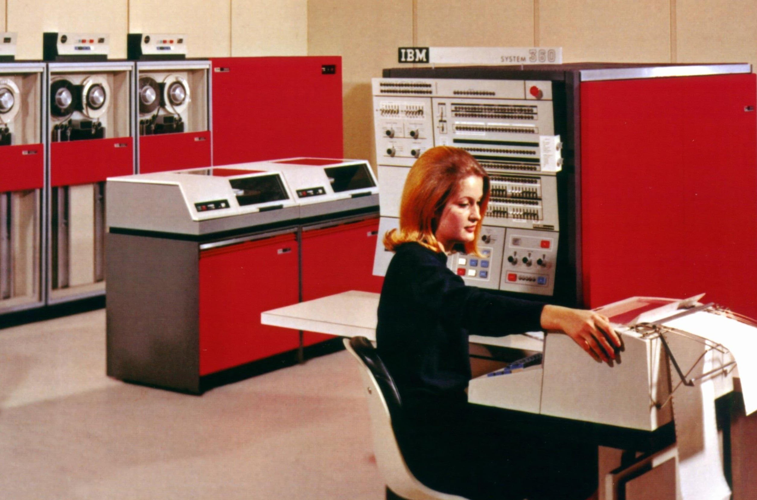 Old photo of woman working with old IBM mainframe
